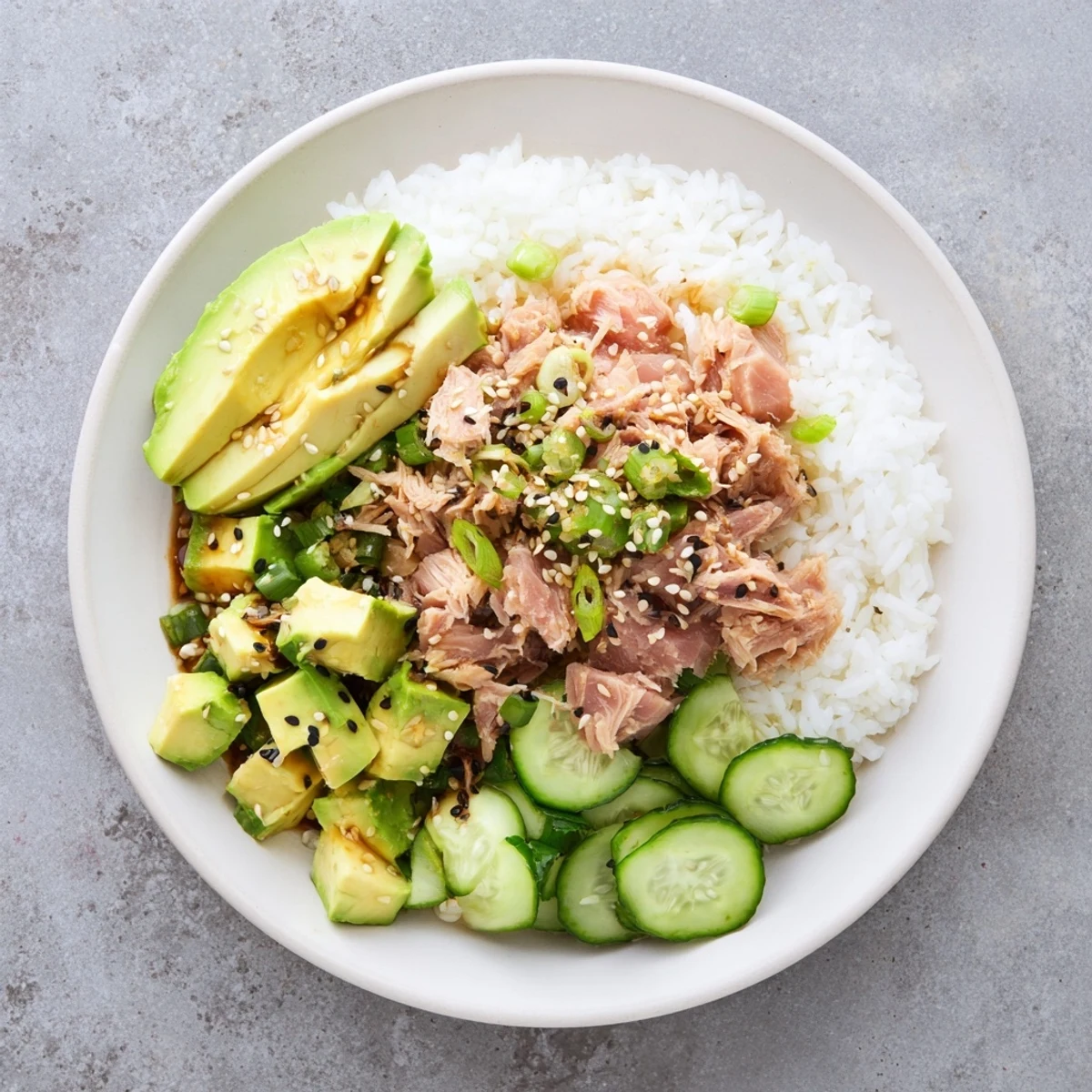 Golden jasmine rice forms the base of this Tuna Avocado Rice Bowl, topped with flaky tuna and creamy diced avocado.  