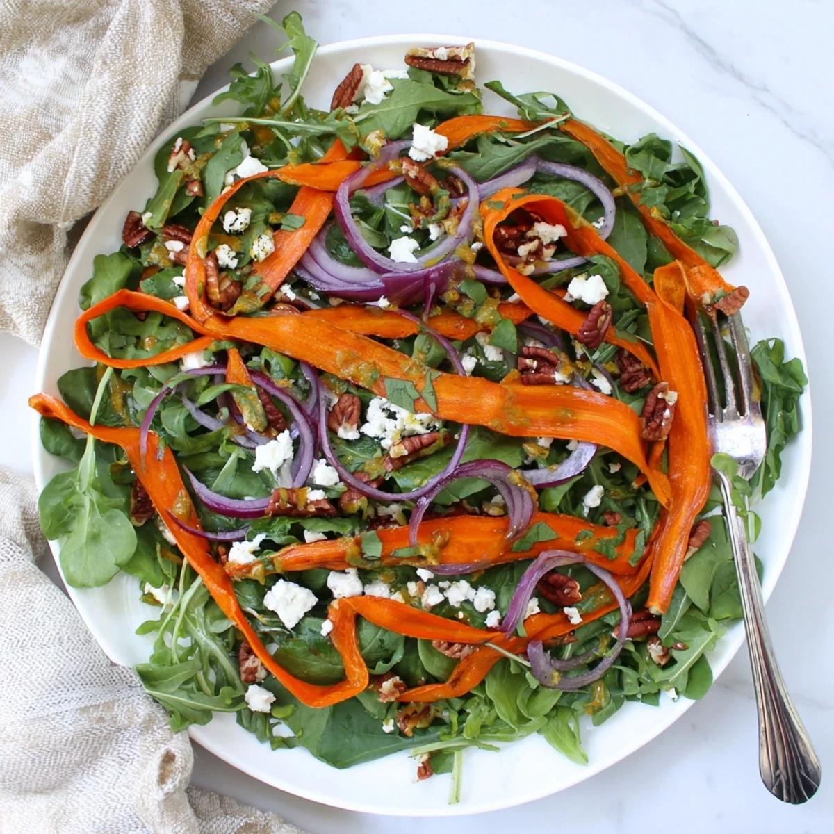 Roasted Carrot Ribbon Salad with tender ribbons over mixed greens, dressed in a sweet honey-mustard vinaigrette.