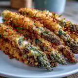 A close-up of Crispy Asparagus Asiago Spears showcasing their crunchy panko and Asiago crust over tender green spears.  