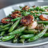 Golden roasted green beans tossed with garlic and finished with bright lemon zest, perfect for holiday meals.  