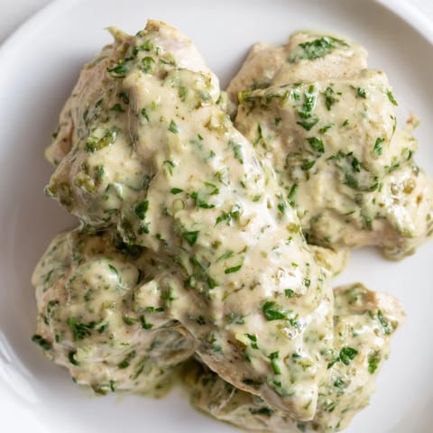 Vibrant Green Goddess Chicken Salad with juicy baked chicken, fresh avocado, and herbs on a bed of mixed greens.
