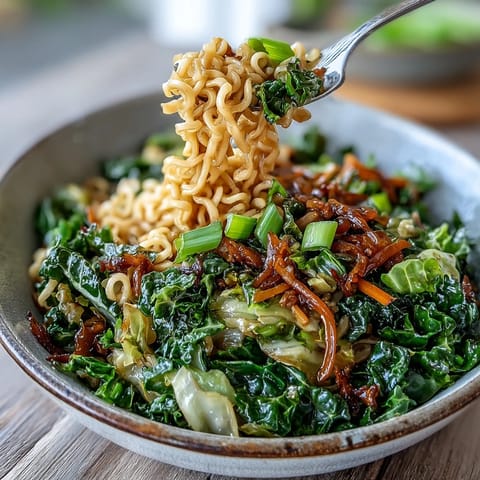 A steaming plate of Fried Cabbage Ramen topped with sliced scallions is ready to serve for dinner.