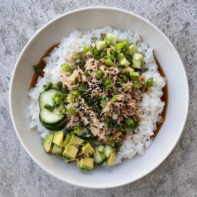 Enjoy this easy Tuna Avocado Rice Bowl drizzled with ginger soy dressing, a perfect fusion-style dinner for two.