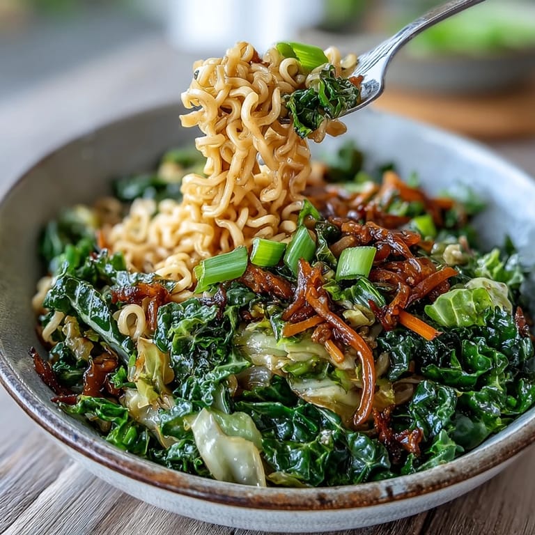A steaming plate of Fried Cabbage Ramen topped with sliced scallions is ready to serve for dinner.