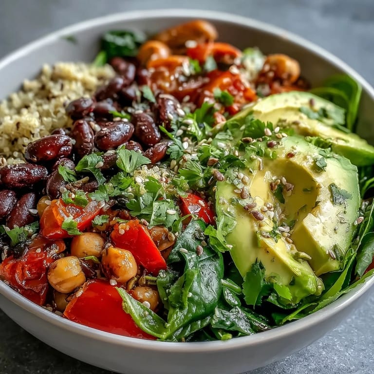 A wholesome Three-Bean Power Bowl featuring chickpeas, black beans, kidney beans, crisp cucumber, and red bell pepper, tossed in tangy lemon Dijon dressing for easy meal prep.